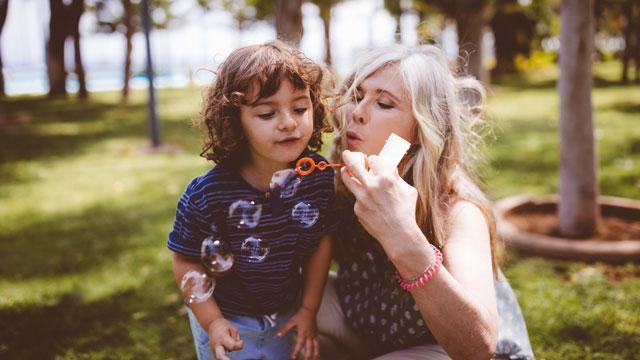 Mom and daughter blowing bubbles.