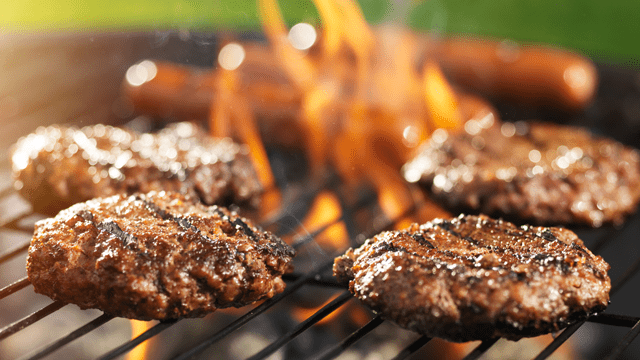 burgers and hot dogs on an outdoor grill