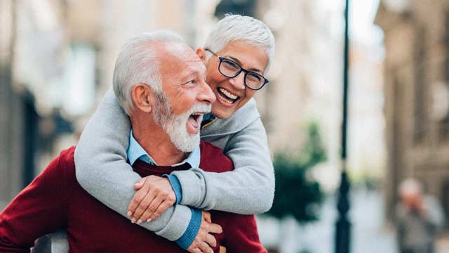 A couple hugging one another on the street.