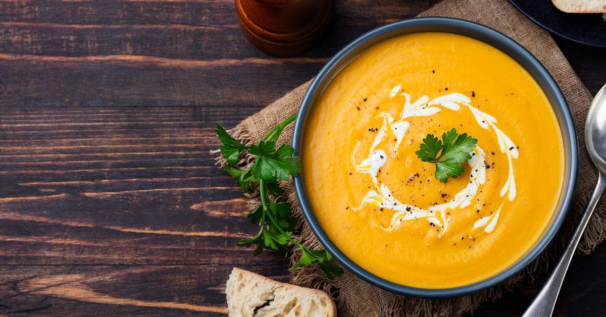 A bowl of soup on a table.