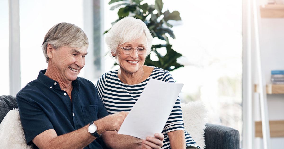 A senior couple reviewing paperwork.