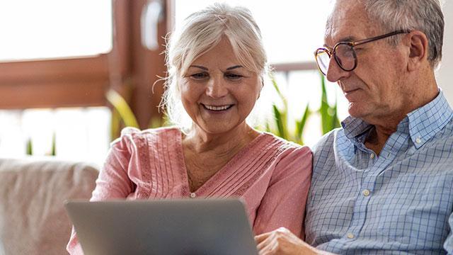 A couple looking at a computer at Hidden Springs of McKinney