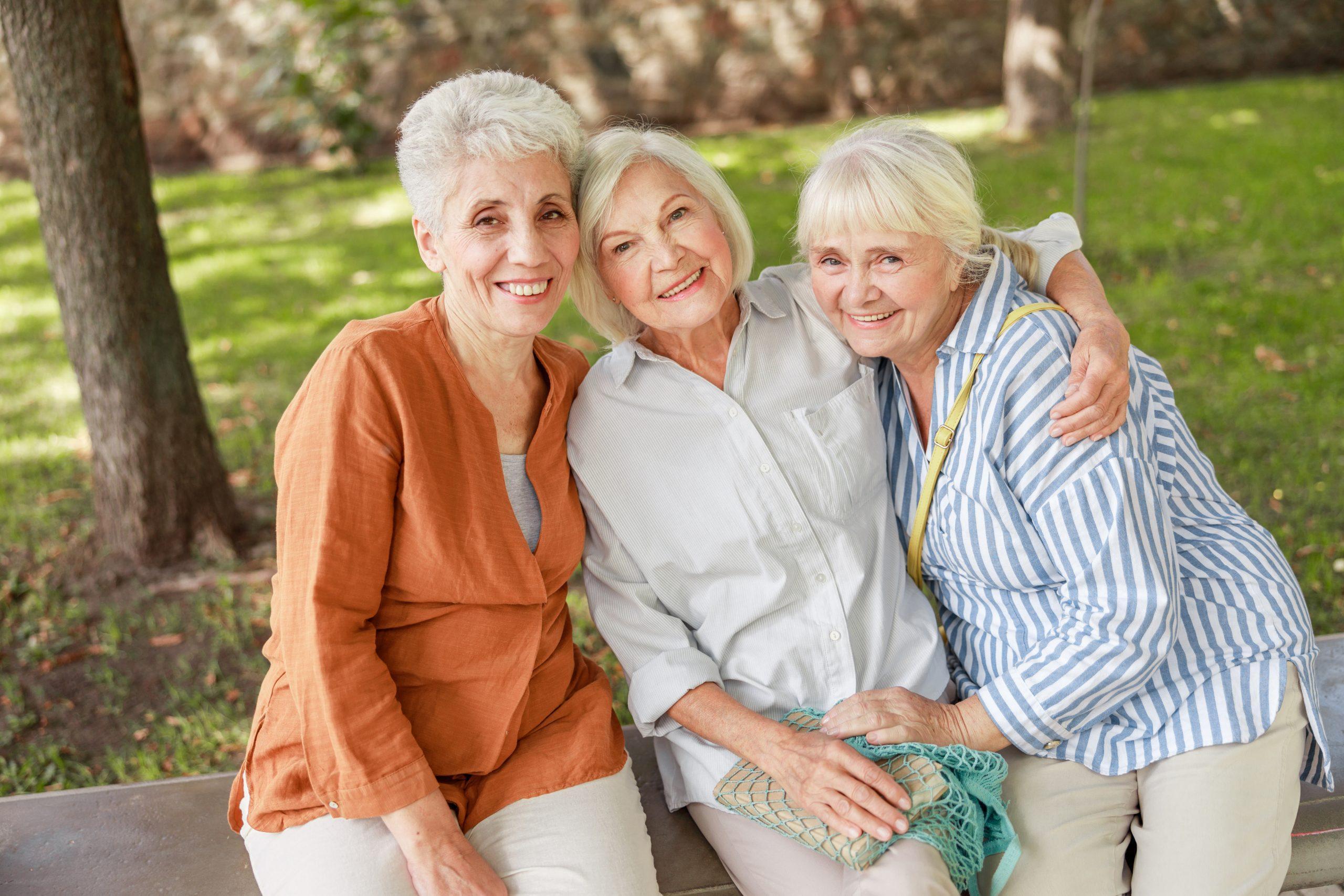 Smiling senior ladies spending time together outdoors stock photo