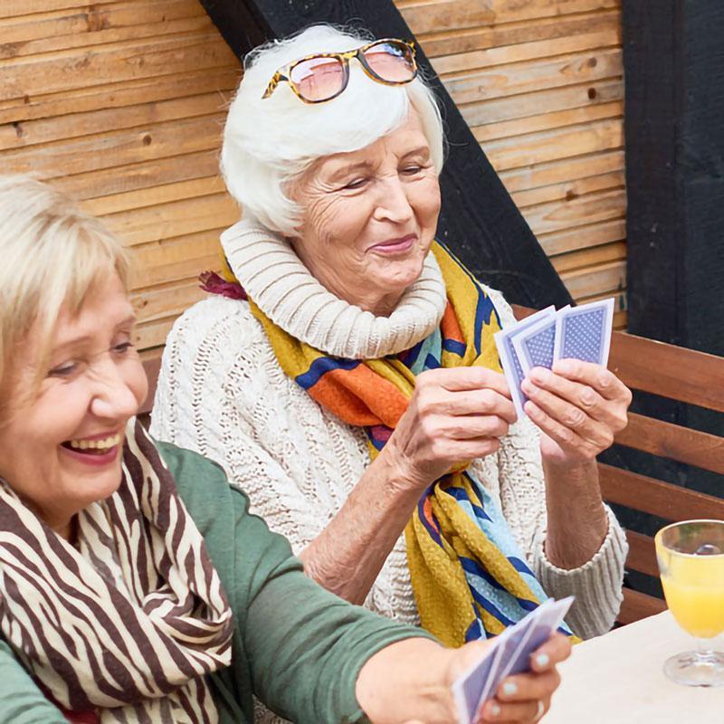 Senior women playing cards